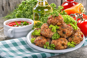 Meatballs of fresh meat with herbs, tomato sauce and vegetables