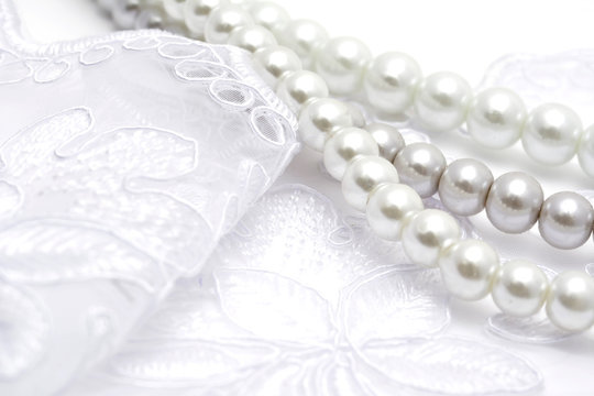 Pearl beads strings on white lace
