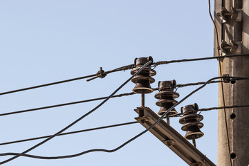 Obraz premium ceramic insulators electric current with wires on a background blue sky