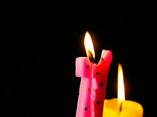 Close-Up of candles against black background
