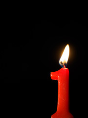 Number1 candle against black background