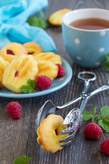 French pastries madeleines with raspberries.