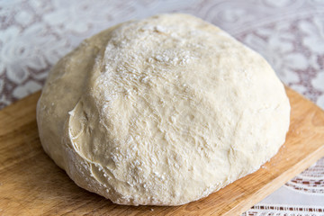 raw yeast dough on a wooden board