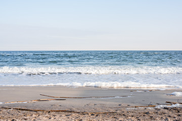 Winter blue sea with foamy waves