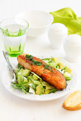 Fresh grilled salmon with a salad of avocado.