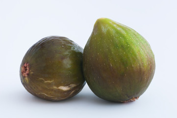 Two ripe figs resting isolated on white background