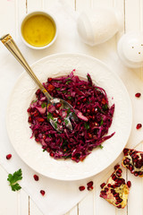 Red cabbage salad with pomegranate seeds.