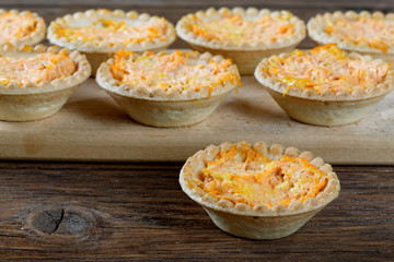 still life of tartlets with cheese and carrots