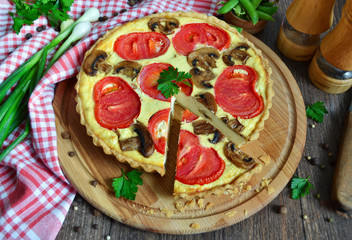 Fototapeta na wymiar Quiche with Adygei cheese, mushrooms and tomatoes