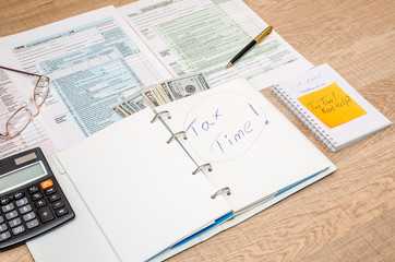 tax form, notepad, calculator and pen