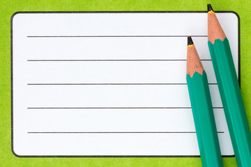Exercise book  name label and pencils