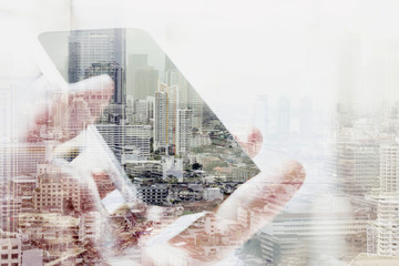 Double exposure image of smart phone and cityscape background,communication technology concept. 