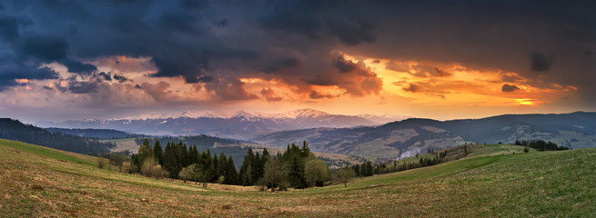 April storm and sunset in mountains. Spring evening