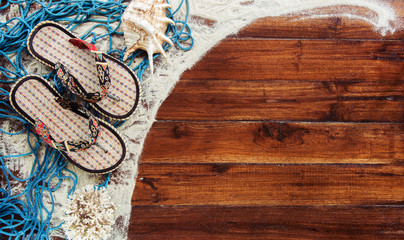 Marine items on wooden background. Sea objects - seashells, corals on wooden planks. Beach still life. View from above