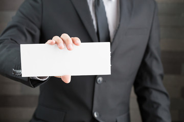 Businessman showing blank signboard