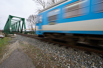 High speed train travel over bridge.