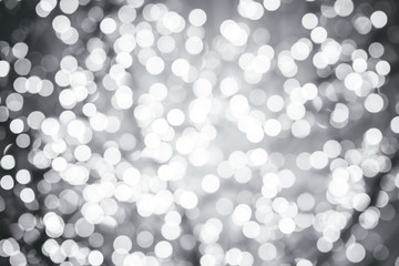 Silver background with natural bokeh defocused sparkling lights. Grey metallic texture with...