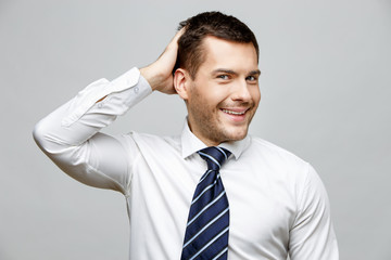 Handsome stylish businessman on grey background