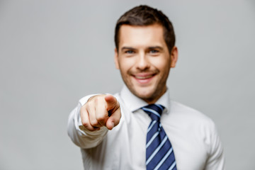 Handsome stylish businessman on grey background