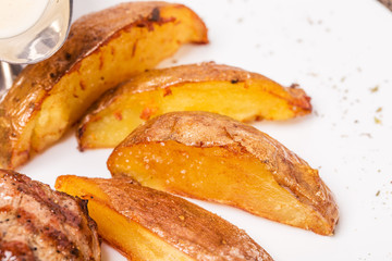 Potato wedges as a garnish for steak.