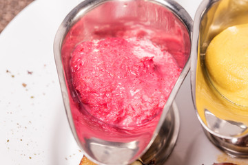 Horseradish and mustard sauces closeup.