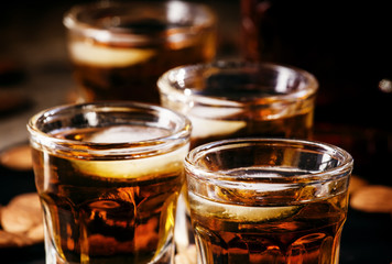 Brandy and almonds, small glasses on a dark background, selectiv