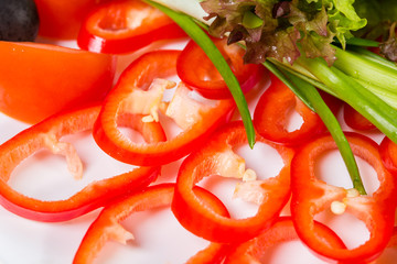 Sliced red paprika with lettuce.