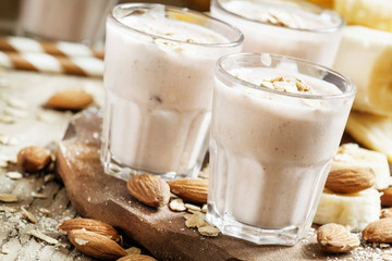 Smoothie with banana, yogurt, oatmeal and nuts, selective focus