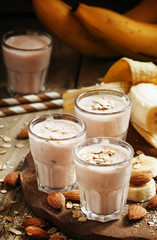 Smoothie with banana, yogurt, oatmeal and nuts, selective focus