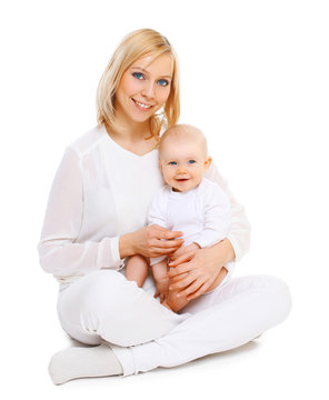 Happy smiling mother with baby sitting together on white backgro