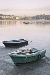 Old green boat moored in the harbor