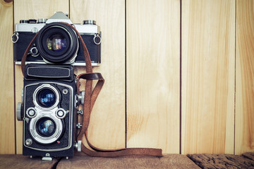 Retro film cameras on wood background with free copy space, vint