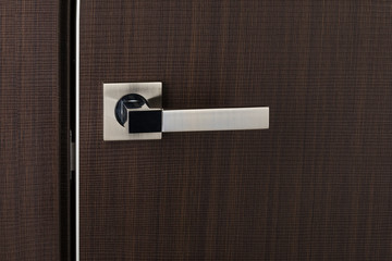 The door leaf with a metal handle, close-up