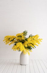 Fototapeta na wymiar Vase with mimosa flowers