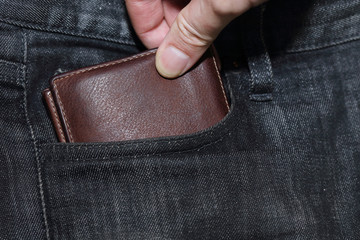 hand stealing wallet from back pocket of jeans