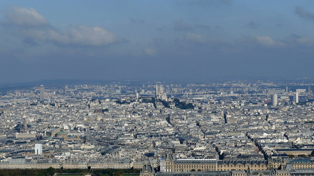 Panoramic footage in 4k with Paris from Montparnasse tower. Aerial view including Louvre Museum and different historical and commercial buildings.