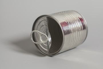 Open an empty tin can on gray background