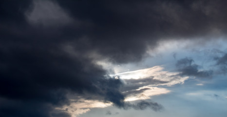 Dark clouds over sun
