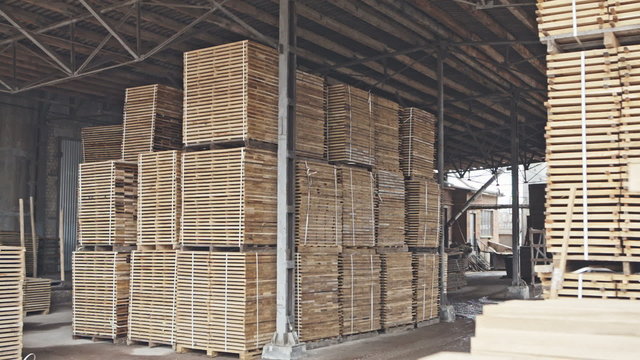 Stack of pile wood bar in lumber yard factory use for construction wood industr. RAW video record.