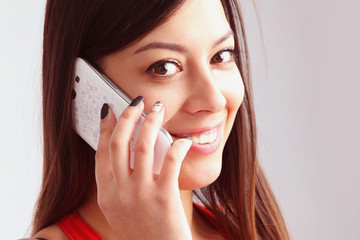 Beautiful young happy woman smiling during a phone call