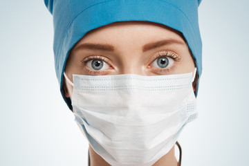 Close-up portrait of female surgeon isolated over background