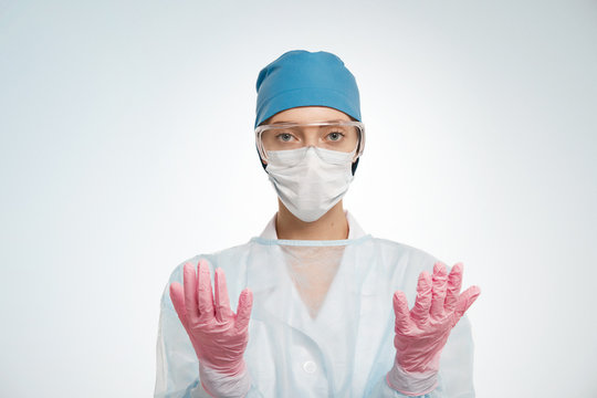 Portrait Of Serious Young Woman Doctor With Mask And Cap