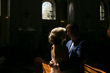 bride and groom illuminated by light