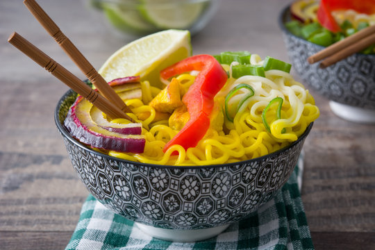 Thai noodles and curry on wood
