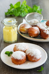With vanilla cream donuts in powdered sugar.