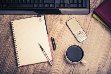 Top View Of An Office Desk With Keyboard, Calendars, Coffee Cup, Cell Phone, Notepad And Fountain Pen. Office Desk In Retro Style.