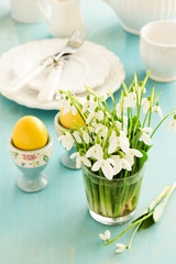 Easter eggs and snowdrops on the holiday table.