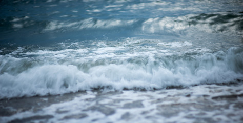 Sea wave foam on the pebble beach