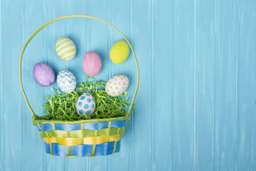 Easter basket and eggs on a blue background