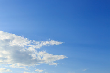 sunlight through cloud on clear blue sky background